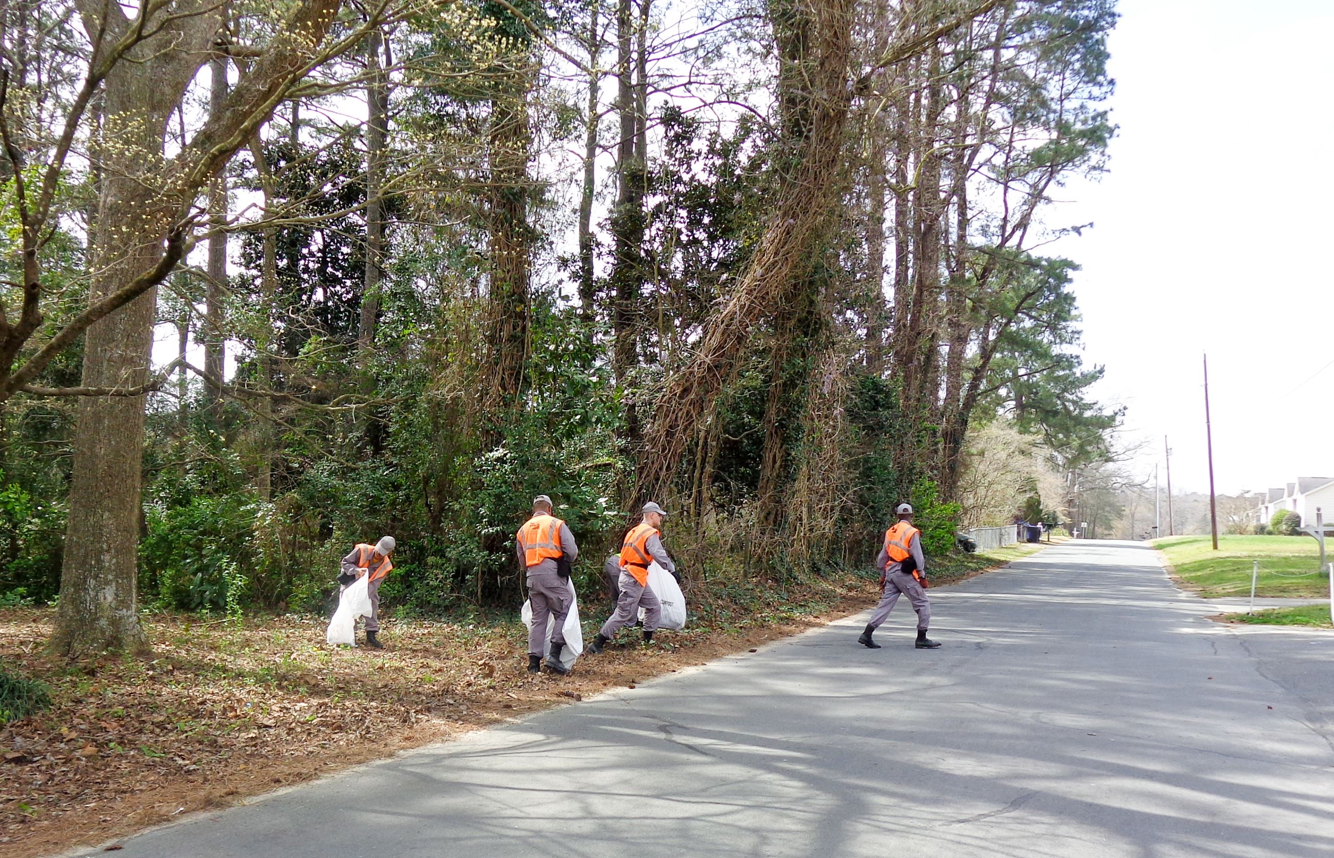 People Cleaning Up Road